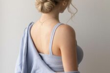 a messy wrapped low bun with a wavy top and some face-framing locks is a chic and feminine solution