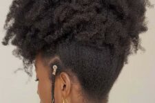 a natural updo with all of the hair swept up into an updo and there are loose braids at the front