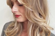 a pretty golden blonde medium butterfly haircut with side bangs and curled ends is a lovely and chic idea