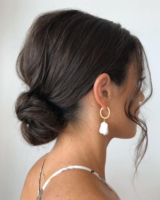 a quick low bun with a messy bump and waves framing the face is a lovely idea for medium-length hair