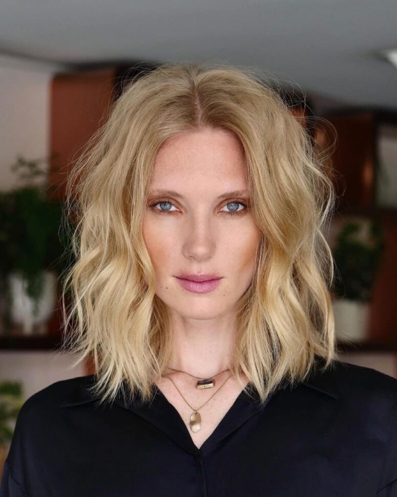 a refined blonde mid-length haircut with longer layers and waves is a lovely idea if you want something edgy