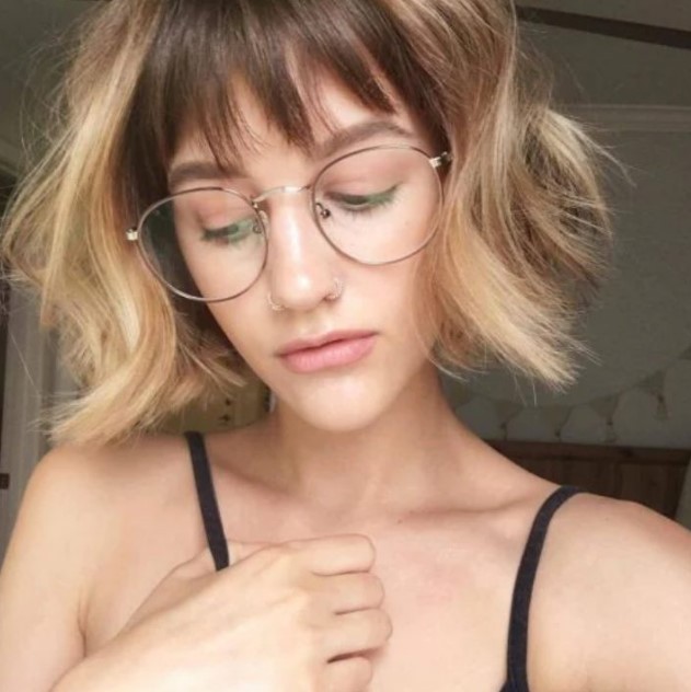 A short blonde bob with dark lowlights and see through wispy bangs is a stylish way to gain extra points
