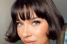 a super short black bob with wispy bangs and curved ends is a cool solution to try if you want a lovely retro look
