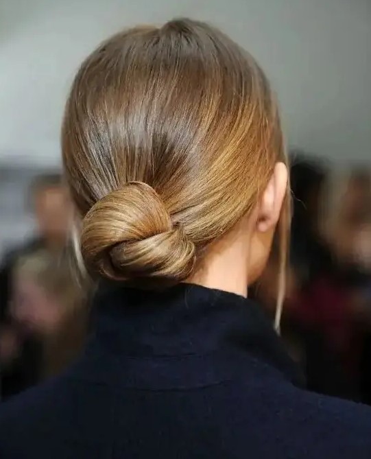 a very sleek twisted low bun with no hairpieces for a chic ultra-minimalist look