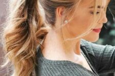 a wavy ponytail with a fishtail braid on one side and some bangs is a relaxed and boho hairstyle idea