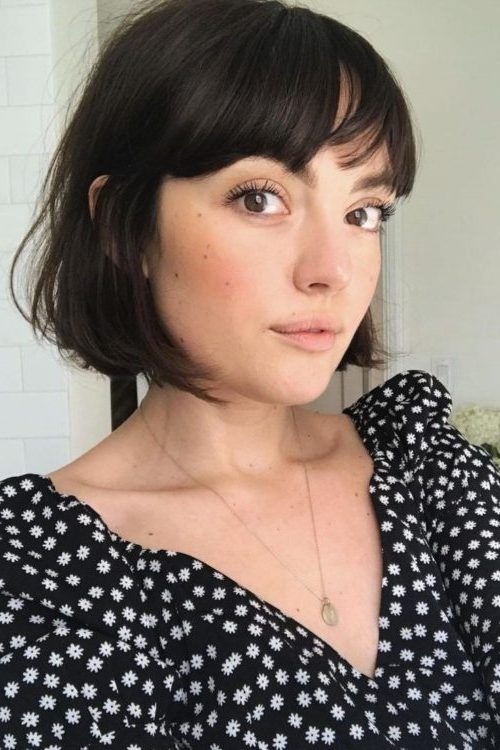 an almost black French bob with wispy and bottleneck bangs is a cool and chic idea to try right now
