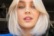 an icy blonde bob with soft curtain bangs and middle part is a cool and stylish idea that looks modern