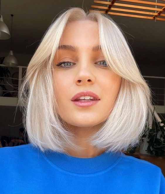 an icy blonde bob with soft curtain bangs and middle part is a cool and stylish idea that looks modern
