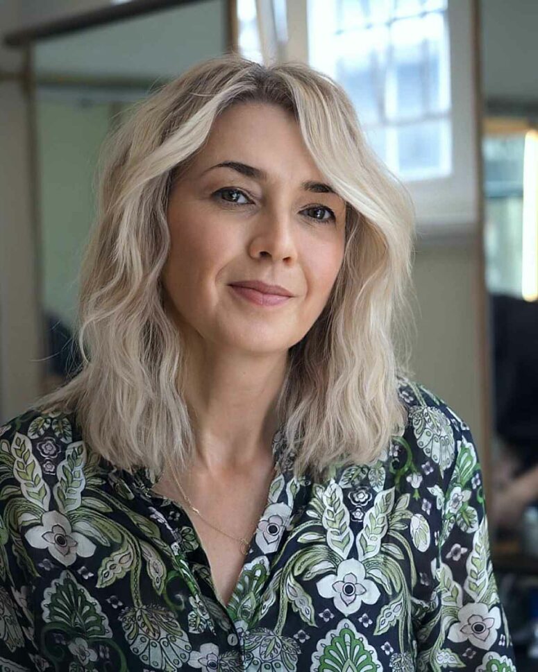 an icy blonde face-framing medium-length haircut is a lovely idea with plenty of volume and texture