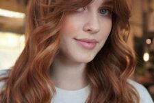 beautiful long ginger hair with shaggy layers and waves plus a soft curtain fringe that accents the eyes