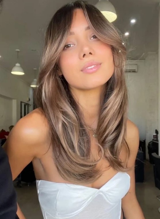 beautiful long light brown hair with lighter accents, chin bangs and curved ends is a beautiful and very summer-like idea