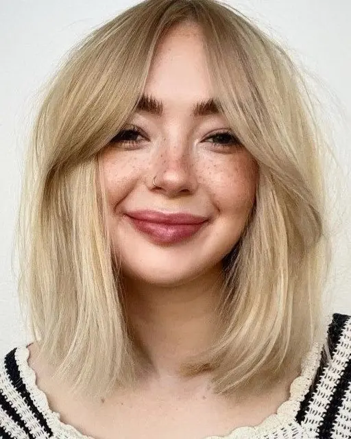 blonde medium length hair with curtain bangs is a pretty and effortlessly chic idea to try right now