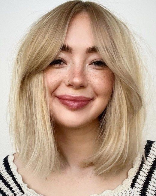 blonde medium-length hair with curtain bangs is a pretty and effortlessly chic idea to try right now