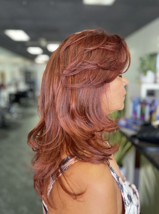 bring a bolder touch to your look with such a bright hair color, a gorgeous butterfly haircut with a lot of volume and curled ends