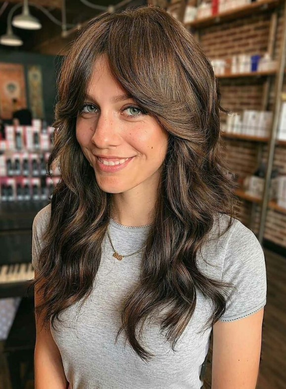 gorgeous long dark brown shaggy hair with long curtain bangs and dimensional highlights is amazing