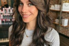 gorgeous long dark brown shaggy hair with long curtain bangs and dimensional highlights is amazing