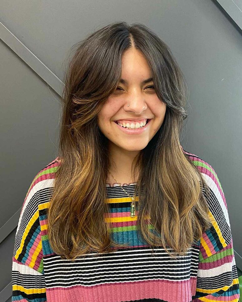 long dark brown hair with a melted balayage and soft layered curtain bangs is a gorgeous idea to try