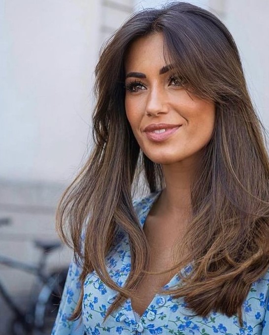 long dark brunette hair with texture and volume, with short curtain bangs looks incredibly chic and beautiful