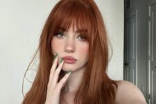 long ginger hair with outgrown wispy bangs is a cool idea, and these bangs beautifully frame the face