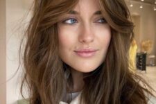 lovely shaggy layered brunette hair with texture and curtain bangs is a cool and chic idea to rock