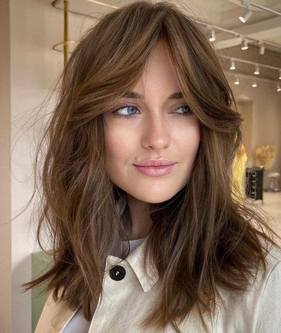 lovely shaggy layered brunette hair with texture and curtain bangs is a cool and chic idea to rock