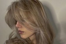 medium blonde hair with long curtain bangs, curled ends and some volume is amazing and looks effortlessly chic