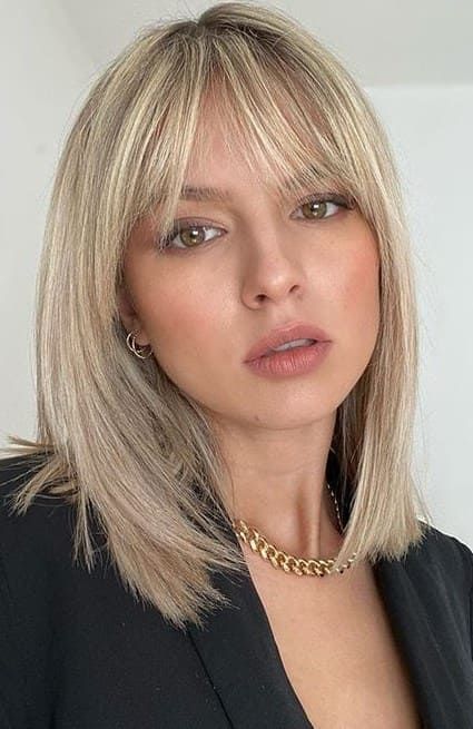 Medium length blonde hair with wispy bangs is a very elegant and stylish solution to try any time, it's classics
