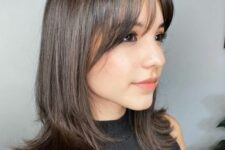 medium-length dark brown hair with a bit of layers and wispy bangs is a lovely and chic idea to rock