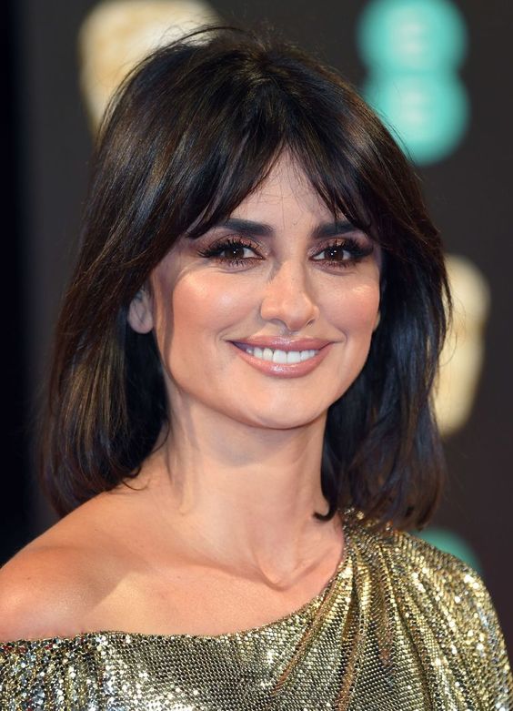 Penelopa Cruz wearing a black long bob with bottleneck bangs and volume looks gorgeous and bold