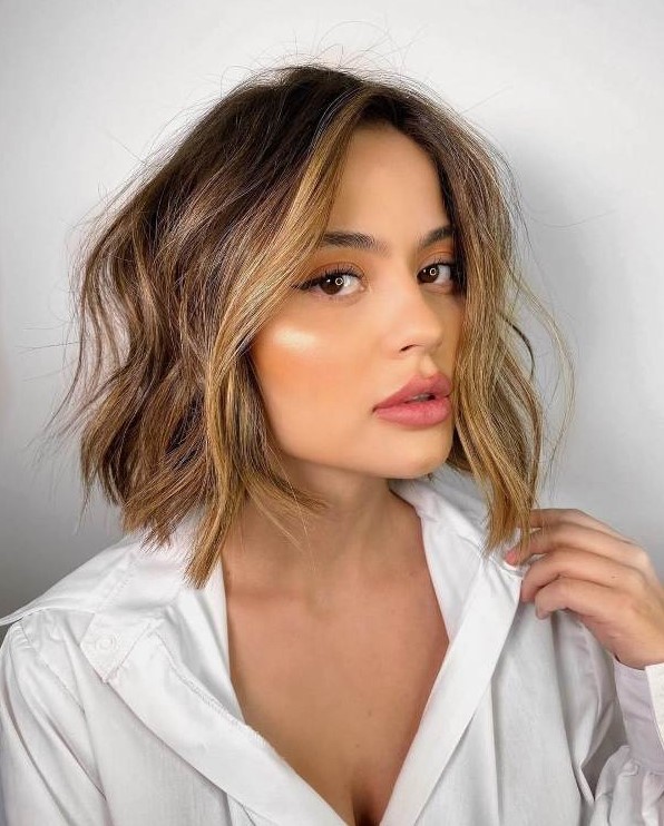 A beautiful brown bob with blonde balayage and face framing locks, with messy texture is a lovely idea