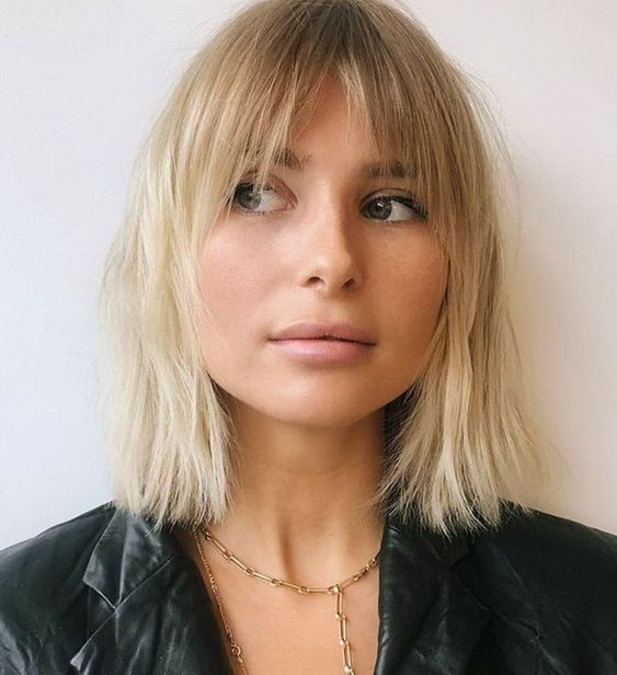 A blonde long bob with bottleneck bangs is cool and low maintenance, it looks effortless
