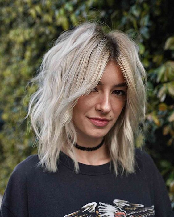a blonde medium wolf cut with a softer shape, a darker root and some messy texture is a lovely idea