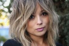 a blonde medium wolf cut with bottleneck bangs, messy texture is a cool and chic idea for anyone who loves blonde shades