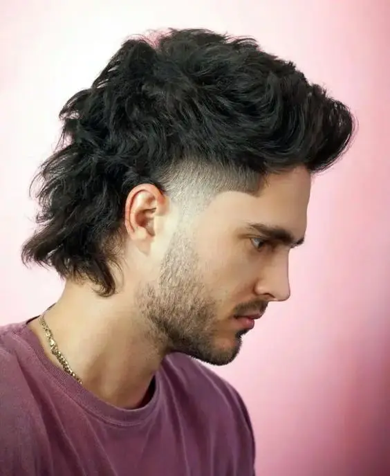 a bold and hot modern black mullet with fade and longer curls on the back looks gorgeous thanks to the natural thick and wavy structure of the hair