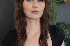 a brunette wolf cut with bangs and waves down looks pretty and very stylized and will give you a 70s look