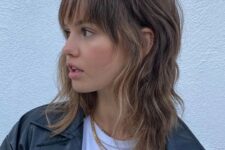 a catchy and chic brown wolf cut with caramel highlights, long bangs and layers is a fresh solution
