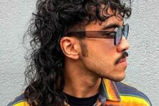 a curly hair wolf cut resembles a mullet and emphasizes the long and flowing curls in the back