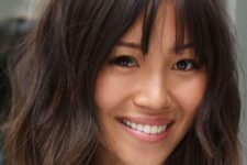 a cute layered lob with bottleneck bangs and a rich brown tone is a very chic and cool idea for a wearing now