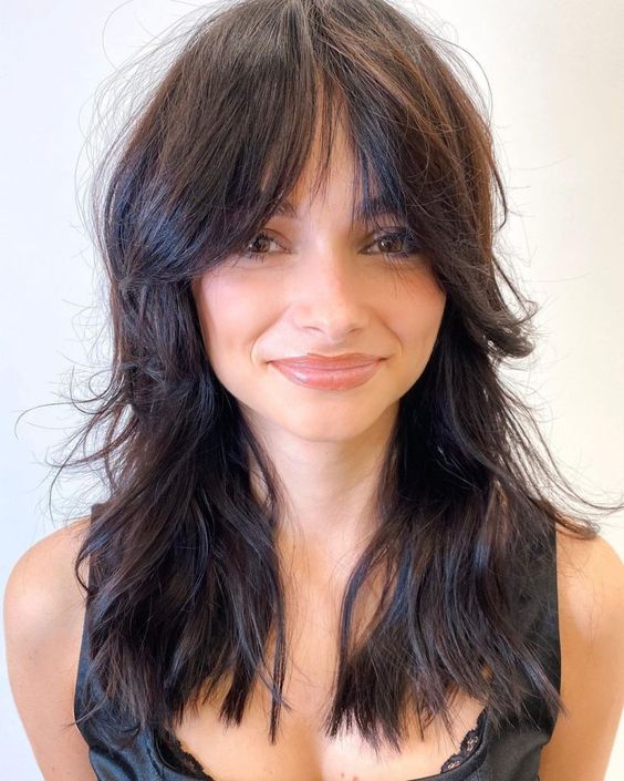 a dark brown long wolf cut with wispy bangs and waves down is a cool solution that you may go for