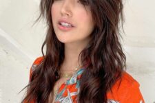 a dark brunette long wolf haircut with bottleneck bangs, waves down and volume is a lovely idea to rock