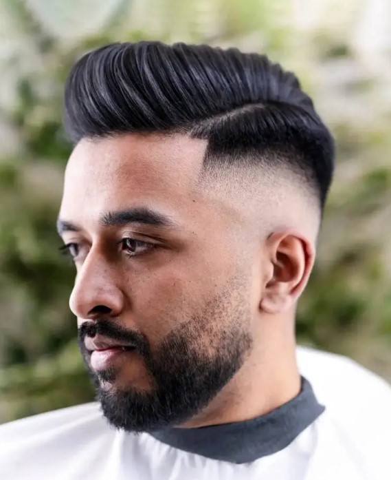 a high fade combover is a versatile haircut, with the top left longer to provide more volume, the beard adds to the style