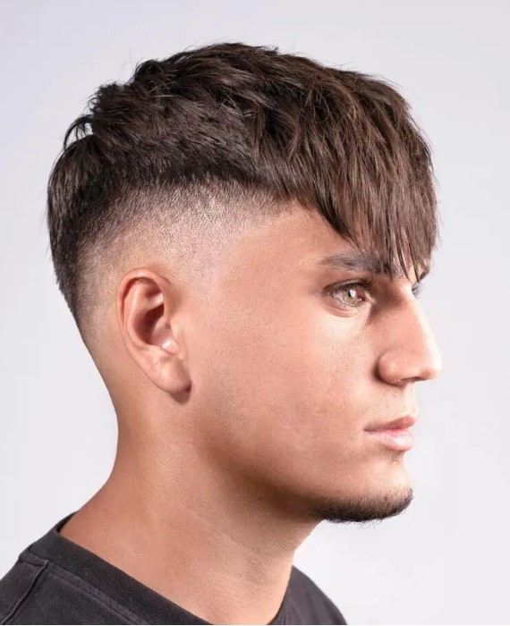 a high skin fade haircut with a textured top and an angle fringe is a bold idea that works for square and oval faces