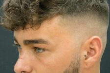 a longer curly tpo paired with a high undercut fade and a stylish beard is a lovely idea for a modern guy