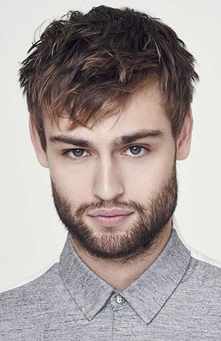 a longer haircut with an angular fringe and textured and a bit tousled hair plus a full beard