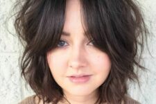 a messy dark brunette wavy long bob with bottleneck bangs is a cool idea that looks relaxed and chic