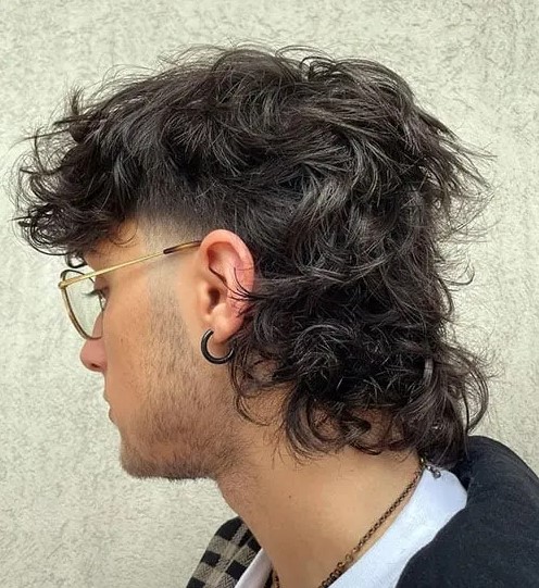 a messy wolf cut with skin fade and curls is a cool idea, you may keep your curls behind your ear and it won't be in sight