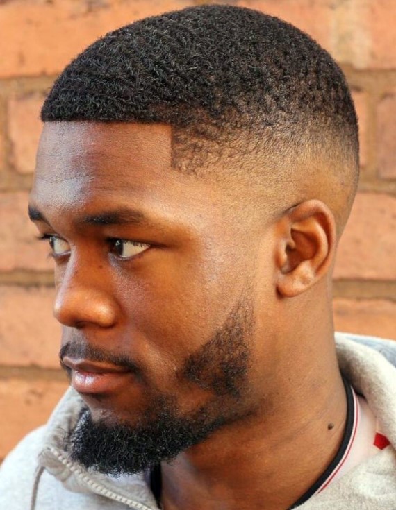 a mid faded buzz cut with a neat line up is a low-maintenance haircut and a beard adds interest