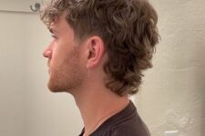 a modern curly mullet with shorter sides, a curly fringe and curls on the back is a soft and subtle version of mullet