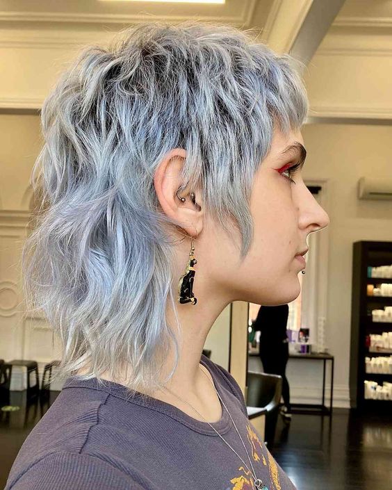 a pale blue short mullet with dimension and waves is a catchy and bold idea that looks rock-style