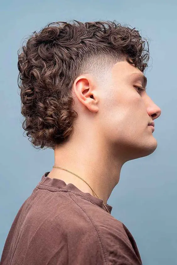 a pretty curly man mullet with faded temple, with thick curls on top and on the back looks absolutely cool